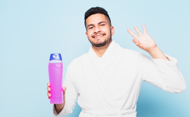 Young hispanic man happy expression and wearing a bathrobe