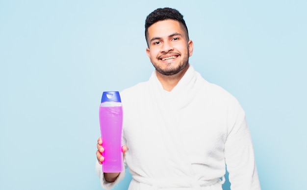 Young hispanic man happy expression and wearing a bathrobe