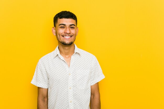 Young hispanic man happy, smiling and cheerful.