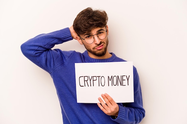 Photo young hispanic man holding a crypto money placard isolated on white background being shocked she has remembered important meeting