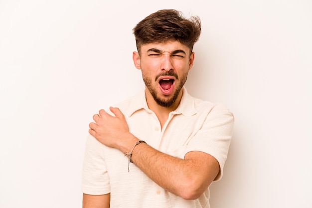 Young hispanic man isolated on white background having a shoulder pain