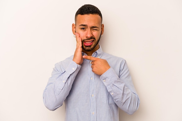 Young hispanic man isolated on white background having a strong teeth pain molar ache