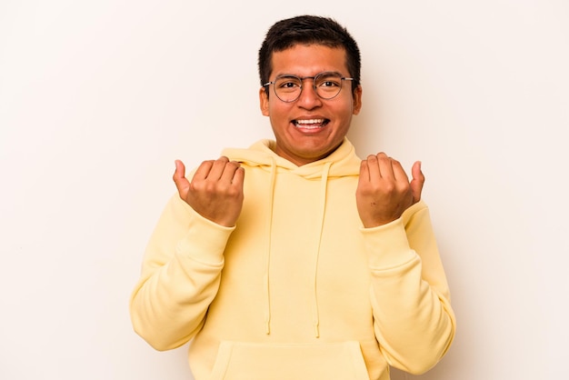 Young hispanic man isolated on white background pointing with finger at you as if inviting come closer