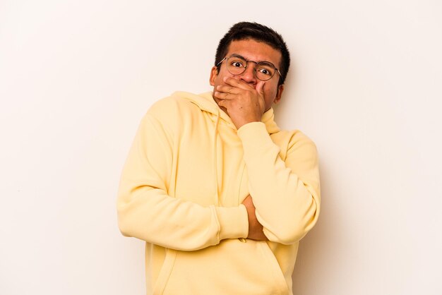 Young hispanic man isolated on white background scared and afraid