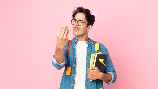 Young hispanic man making capice or money gesture, telling you to pay. student concept