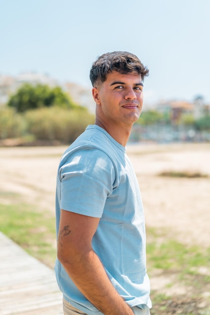 Young hispanic man at outdoors with happy expression