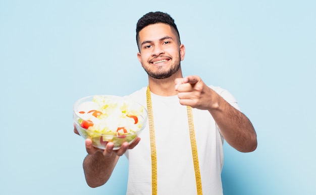 Young hispanic man pointing or showing