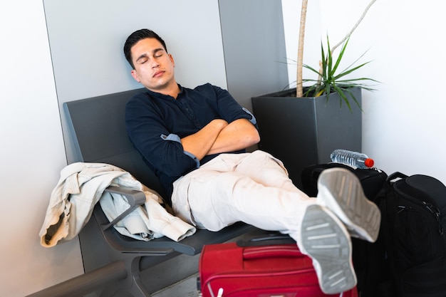 Young hispanic man rest in waiting room in airport or station Travel delays concept