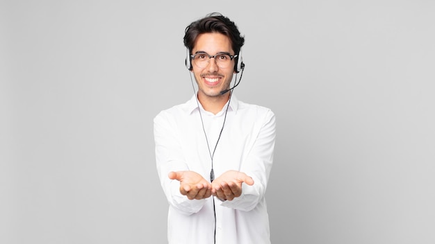 Young hispanic man smiling happily with friendly and  offering and showing a concept. telemarketer concept