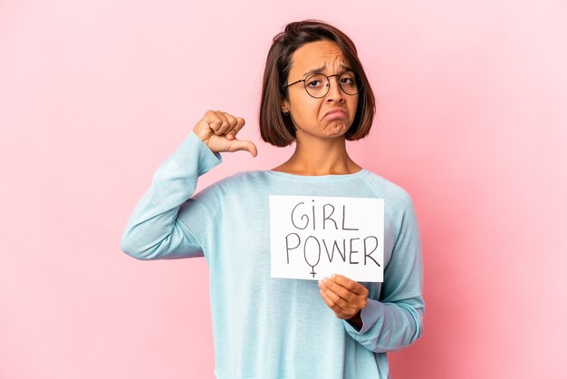 Young hispanic mixed race woman holding a girl power message placard feels proud and self confident, example to follow.