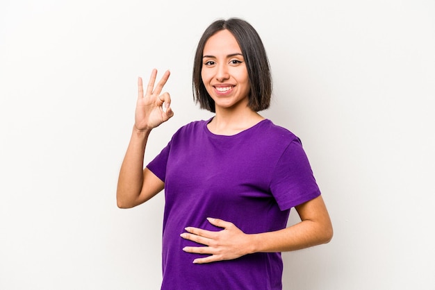 Young hispanic pregnant woman isolated on white background cheerful and confident showing ok gesture