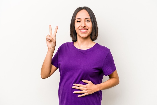 Young hispanic pregnant woman isolated on white background showing number two with fingers