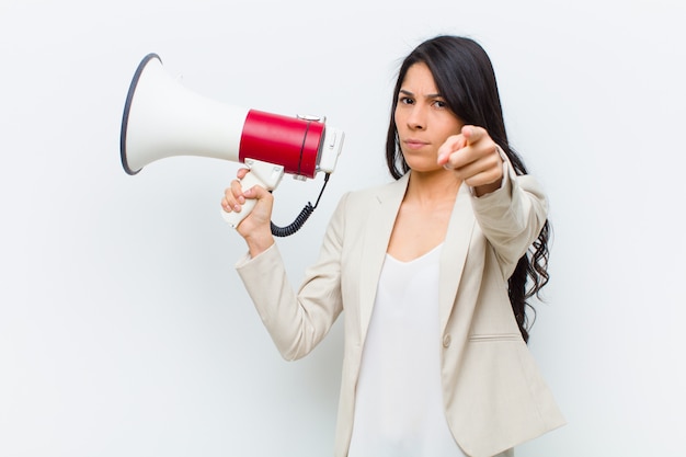 Young hispanic pretty woman with a megaphone