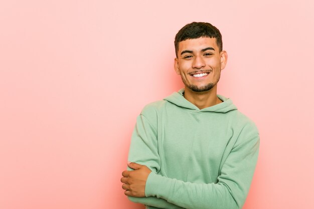 Young hispanic sport man who feels confident, crossing arms with determination.