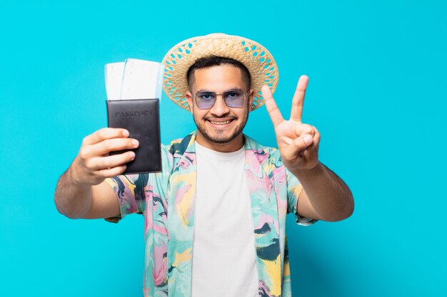 Young hispanic traveler man celebrating successful a victory