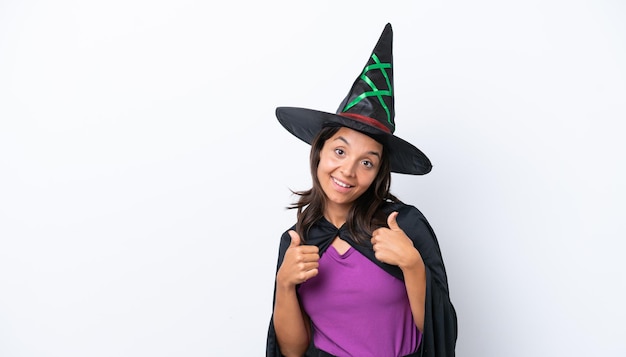 Young hispanic woman dressed as witch over isolated background giving a thumbs up gesture