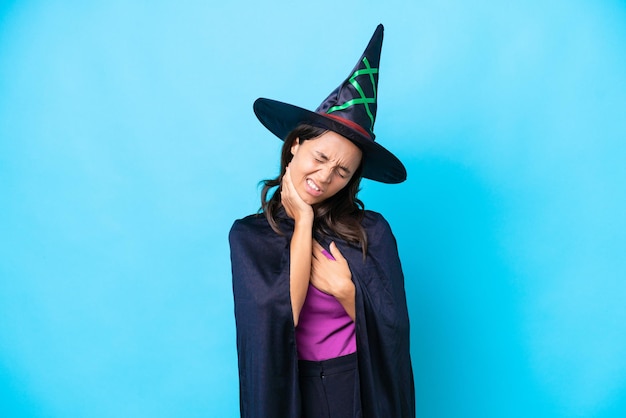 Young hispanic woman dressed as witch over isolated background with neckache