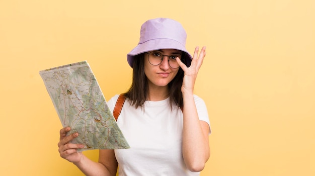 Young hispanic woman feeling bored frustrated and sleepy after a tiresome tourist and map concept