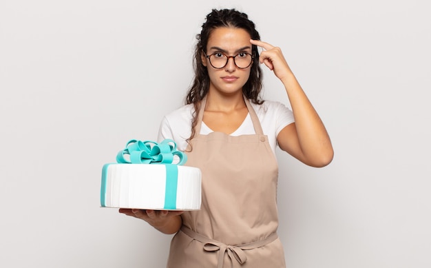 Young hispanic woman feeling confused and puzzled, showing you are insane, crazy or out of your mind