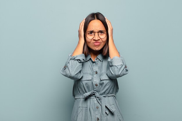 Young hispanic woman feeling frustrated and annoyed, sick and tired of failure, fed-up with dull, boring tasks