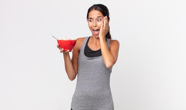 Young hispanic woman feeling happy, excited and surprised. fitness diet and breakfast concept