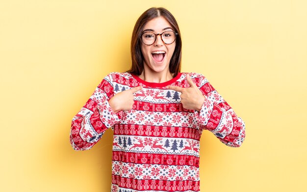 Young hispanic woman feeling happy and pointing to self with an excited. chistmas and new year concept