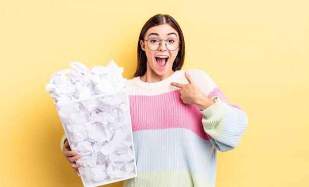 Young hispanic woman feeling happy and pointing to self with an excited. failure trash concept