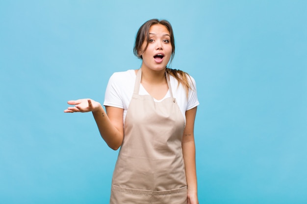 Young hispanic woman feeling happy, surprised and cheerful, smiling with positive attitude, realizing a solution or idea