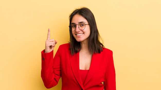 Young hispanic woman feeling like a happy and excited genius after realizing an idea business concept