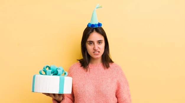 Young hispanic woman feeling puzzled and confused birthday concept