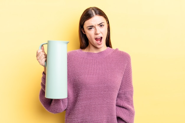 Young hispanic woman feeling puzzled and confused. coffee thermos concept