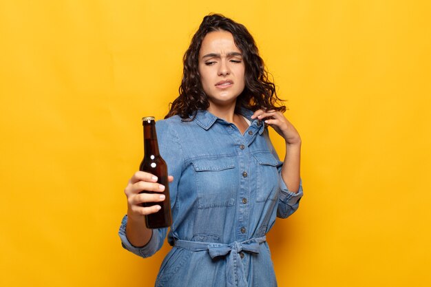 Young hispanic woman feeling stressed, anxious, tired and frustrated, pulling shirt neck, looking frustrated with problem