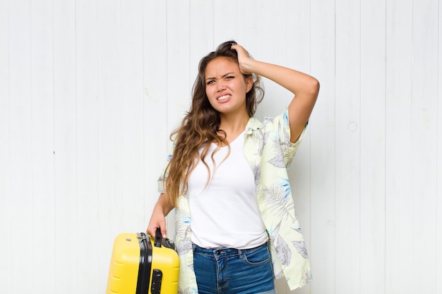 Young hispanic woman feeling stressed, worried, anxious or scared, with hands on head, panicking at mistake