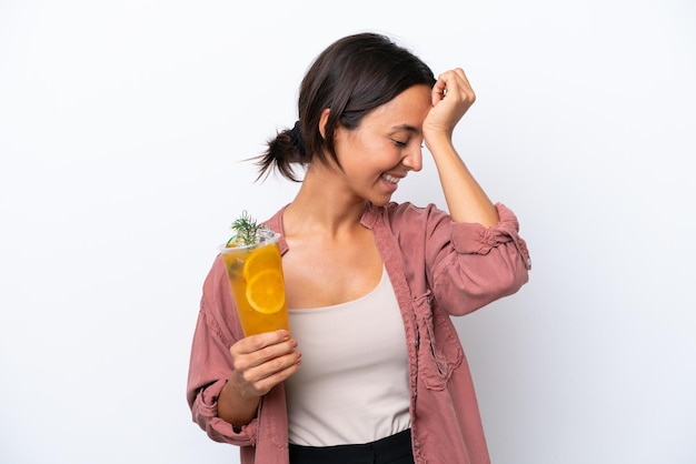 Young hispanic woman holding a cocktail isolated on white background has realized something and intending the solution