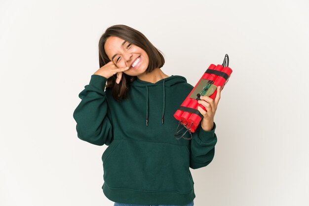 Young hispanic woman holding dynamite showing a mobile phone call gesture with fingers