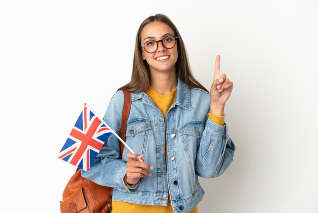 Young hispanic woman holding an United Kingdom flag over isolated white background showing and lifting a finger in sign of the best