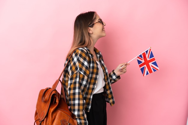 Young hispanic woman holding an United Kingdom flag isolated