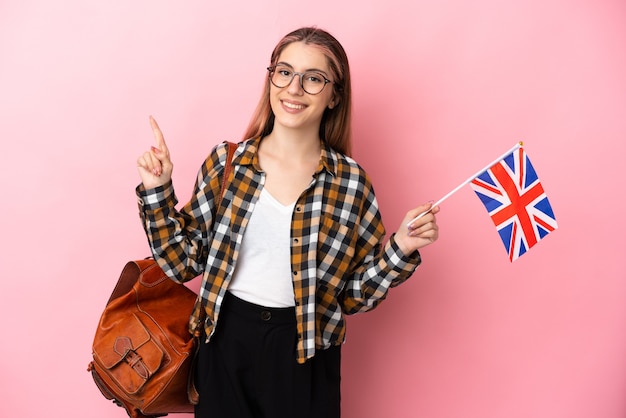 Young hispanic woman holding an United Kingdom flag isolated