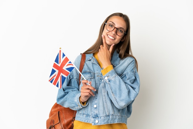 Young hispanic woman holding an United Kingdom flag isolated