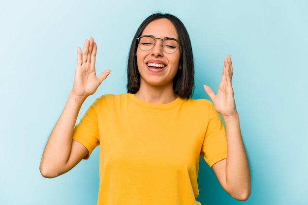 Young hispanic woman isolated on blue background joyful laughing a lot Happiness concept