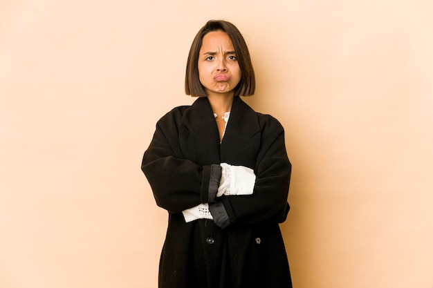 Young hispanic woman isolated frowning face in displeasure, keeps arms folded.