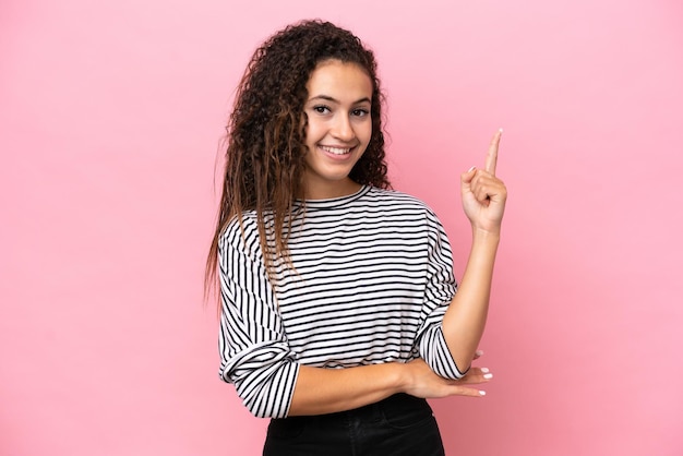 Photo young hispanic woman isolated on pink background happy and pointing up