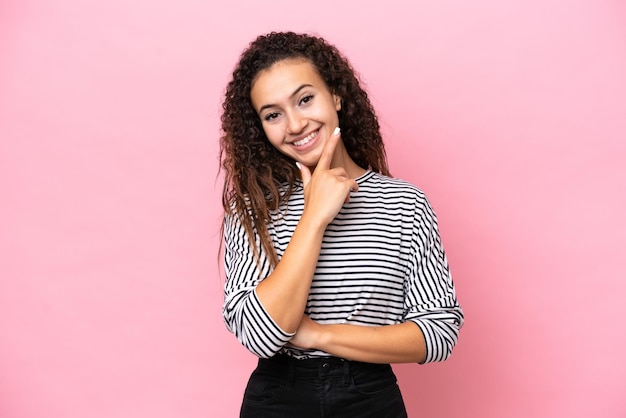 Young hispanic woman isolated on pink background happy and smiling