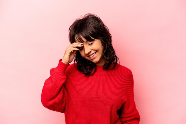 Young hispanic woman isolated on pink background joyful laughing a lot Happiness concept