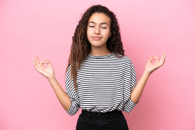 Young hispanic woman isolated on pink background in zen pose