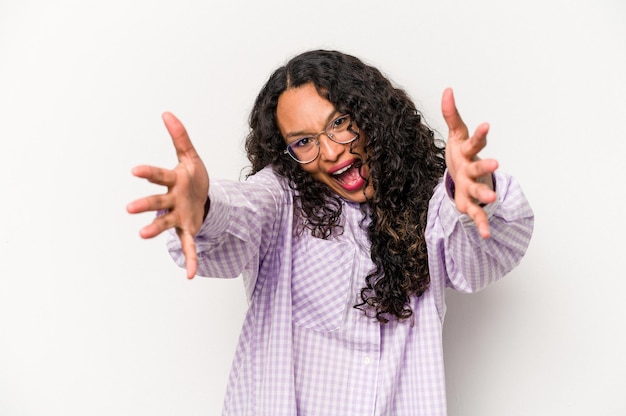 Young hispanic woman isolated on white background feels confident giving a hug to the camera