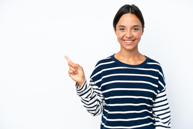 Young hispanic woman isolated on white background pointing to the side to present a product