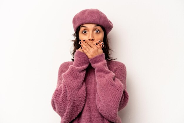 Young hispanic woman isolated on white background shocked covering mouth with hands