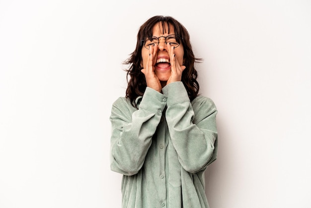 Young hispanic woman isolated on white background shouting excited to front