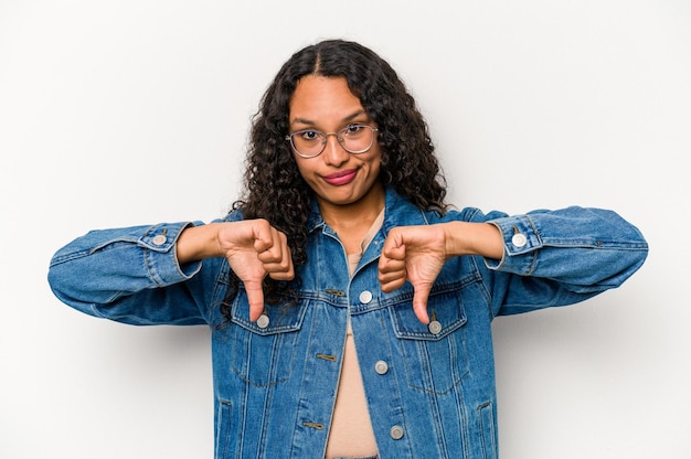 Young hispanic woman isolated on white background showing thumb down disappointment concept